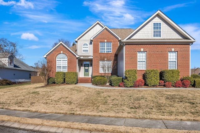 view of front facade featuring brick siding and a front yard