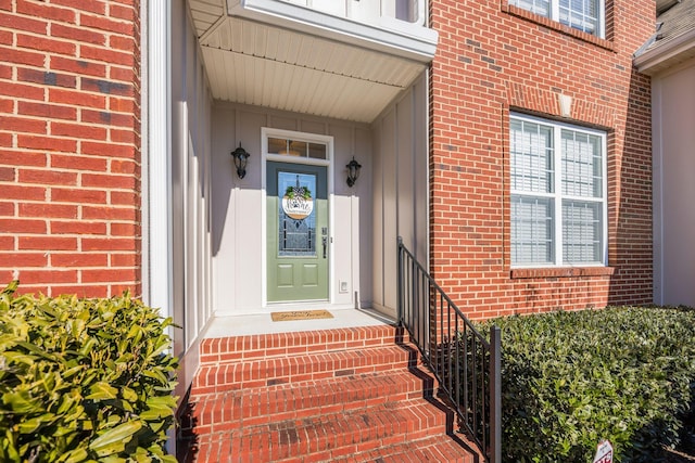 doorway to property featuring brick siding