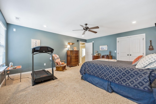 bedroom featuring visible vents, baseboards, ceiling fan, carpet, and a closet