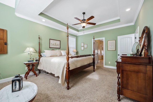 bedroom featuring baseboards, a raised ceiling, crown molding, and recessed lighting