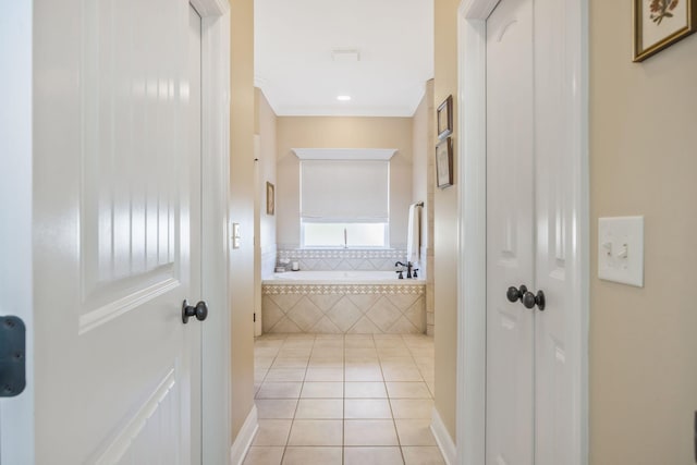 full bath featuring a garden tub and tile patterned floors