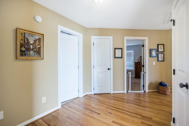 interior space featuring light wood finished floors and baseboards