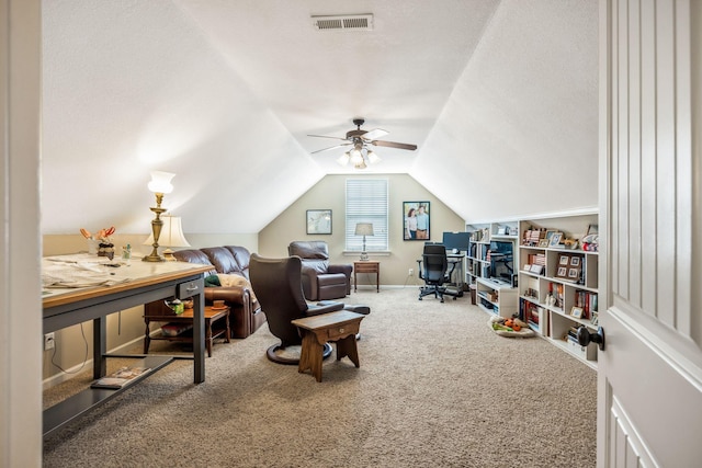 carpeted office with baseboards, visible vents, lofted ceiling, ceiling fan, and a textured ceiling