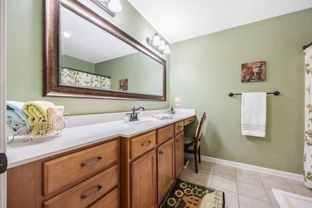 bathroom featuring tile patterned flooring, baseboards, and vanity