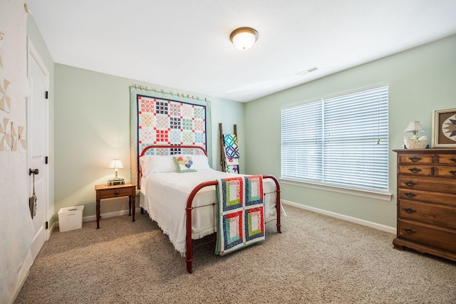 carpeted bedroom featuring visible vents and baseboards