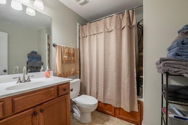 full bathroom with tile patterned flooring, vanity, toilet, and shower / bath combo with shower curtain