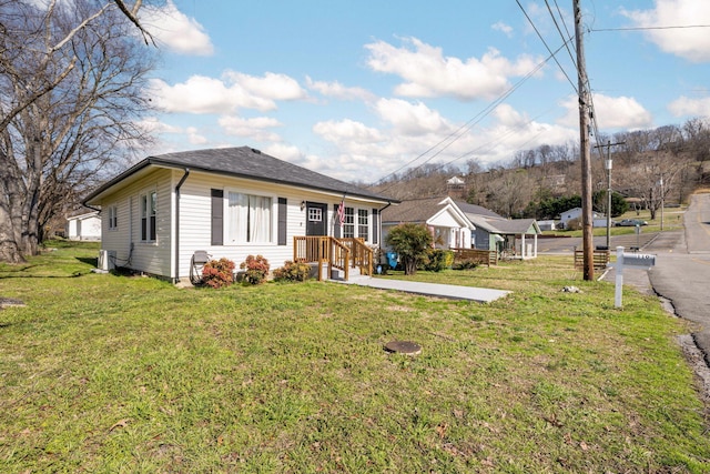 bungalow-style house with a front lawn and a shingled roof