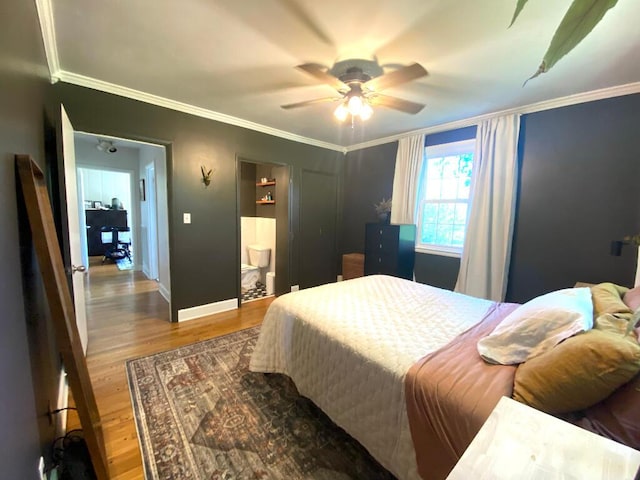 bedroom featuring crown molding, wood-type flooring, ceiling fan, and ensuite bathroom