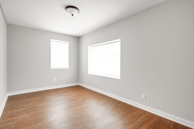 empty room with hardwood / wood-style flooring