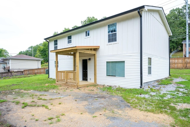 back of property featuring a yard