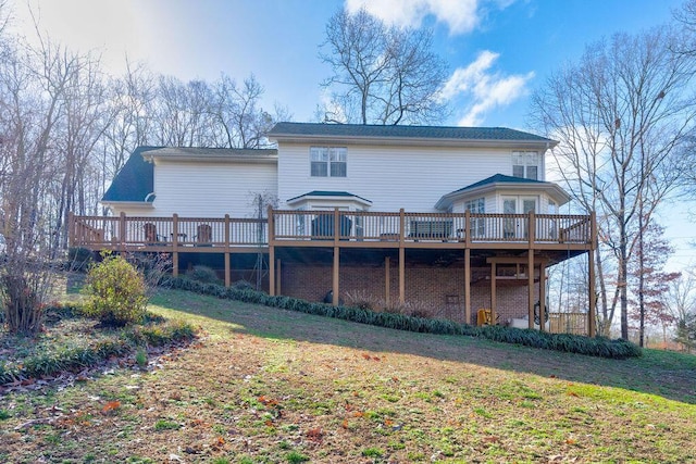 back of house with a wooden deck and a lawn