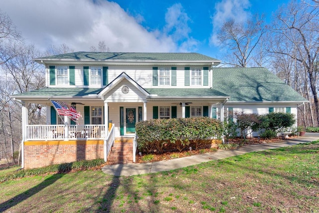 view of front of house with a porch and a front yard