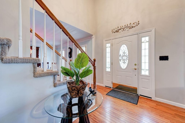 foyer featuring a high ceiling and light hardwood / wood-style flooring