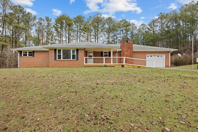 ranch-style home with a garage, a front lawn, and covered porch