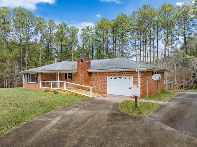 single story home with a garage, covered porch, and a front lawn