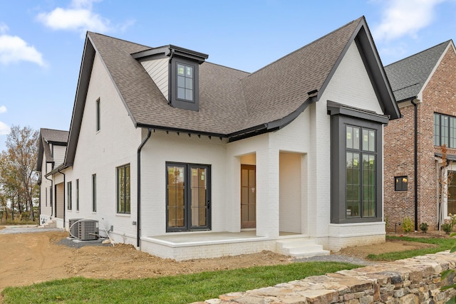 rear view of house featuring central AC