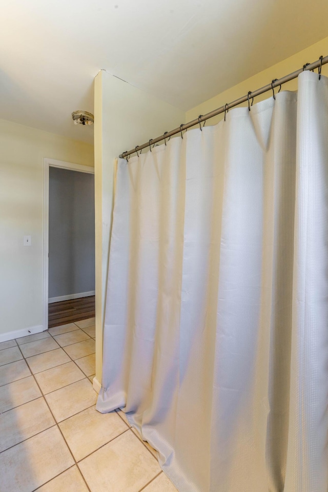 bathroom featuring tile patterned flooring and baseboards