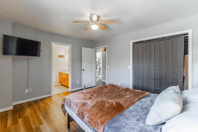 bedroom featuring ceiling fan, ensuite bath, wood finished floors, and baseboards