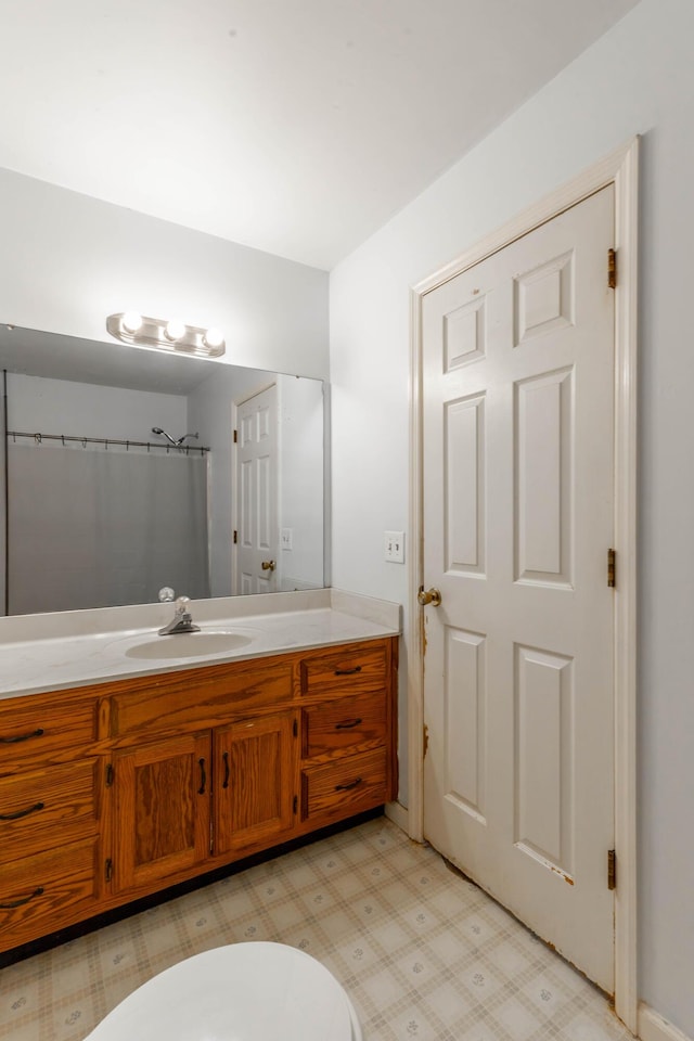 bathroom with vanity, toilet, and tile patterned floors