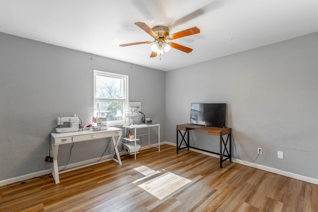 office area featuring ceiling fan, wood finished floors, and baseboards