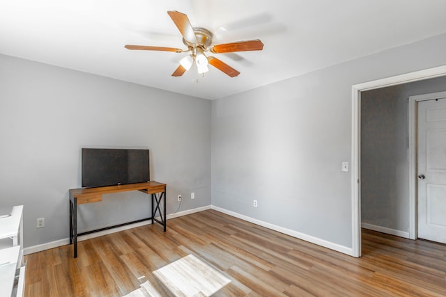 bedroom with ceiling fan, baseboards, and wood finished floors