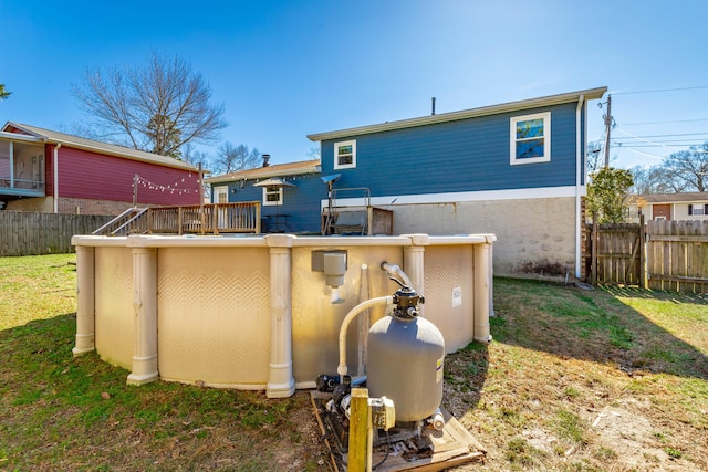 back of property with fence and a lawn