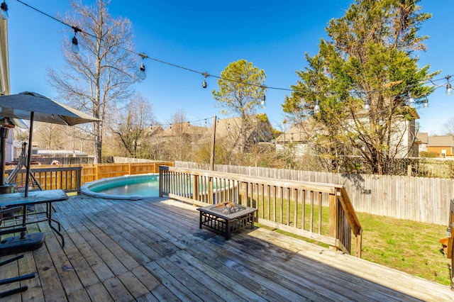 deck featuring a fenced backyard and a lawn