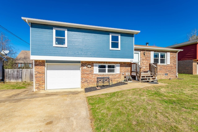 view of front facade featuring a garage, a front yard, fence, and brick siding