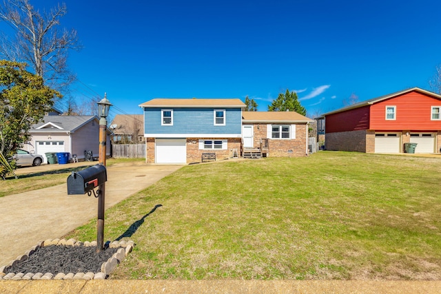 tri-level home with a garage, brick siding, fence, concrete driveway, and a front yard