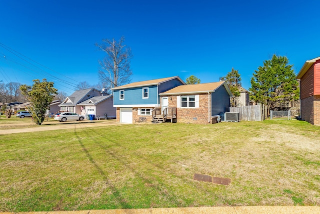 back of property featuring driveway, crawl space, an attached garage, fence, and brick siding