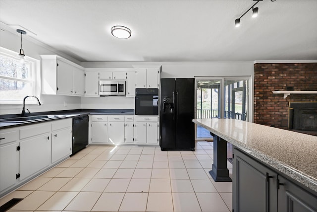 kitchen with black appliances, white cabinetry, a sink, and decorative light fixtures