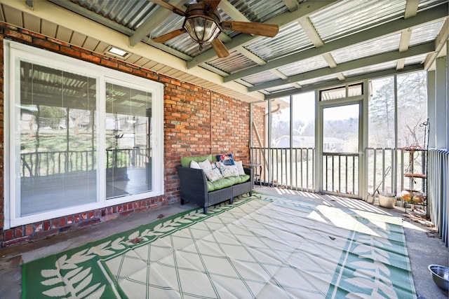 unfurnished sunroom with a ceiling fan