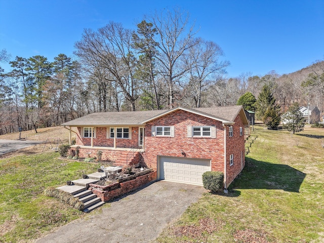 view of front of property with stairway, aphalt driveway, an attached garage, a front yard, and brick siding