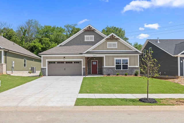 8892 Knolling Loop Unit 34, Ooltewah, TN 37363 - craftsman-style home with board and batten siding, cooling unit, an attached garage, concrete driveway, and a front lawn
