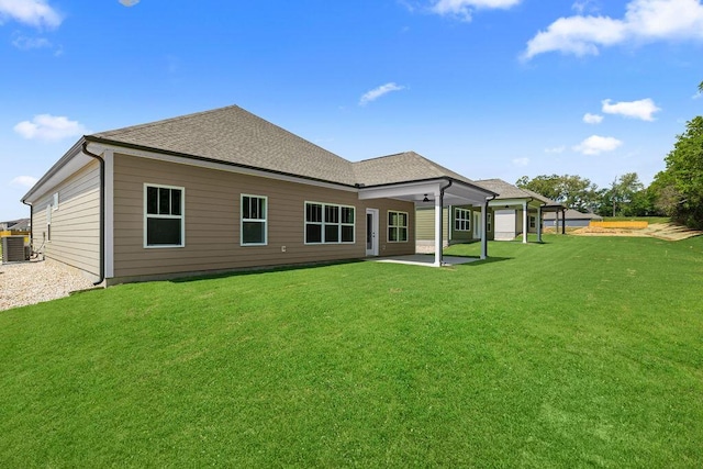 8892 Knolling Loop Unit 34, Ooltewah, TN 37363 - rear view of property featuring a patio, a yard, a shingled roof, and cooling unit