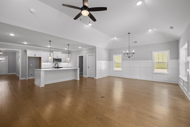 8892 Knolling Loop Unit 34, Ooltewah, TN 37363 - unfurnished living room with a chandelier, ceiling fan, a wainscoted wall, vaulted ceiling, and recessed lighting