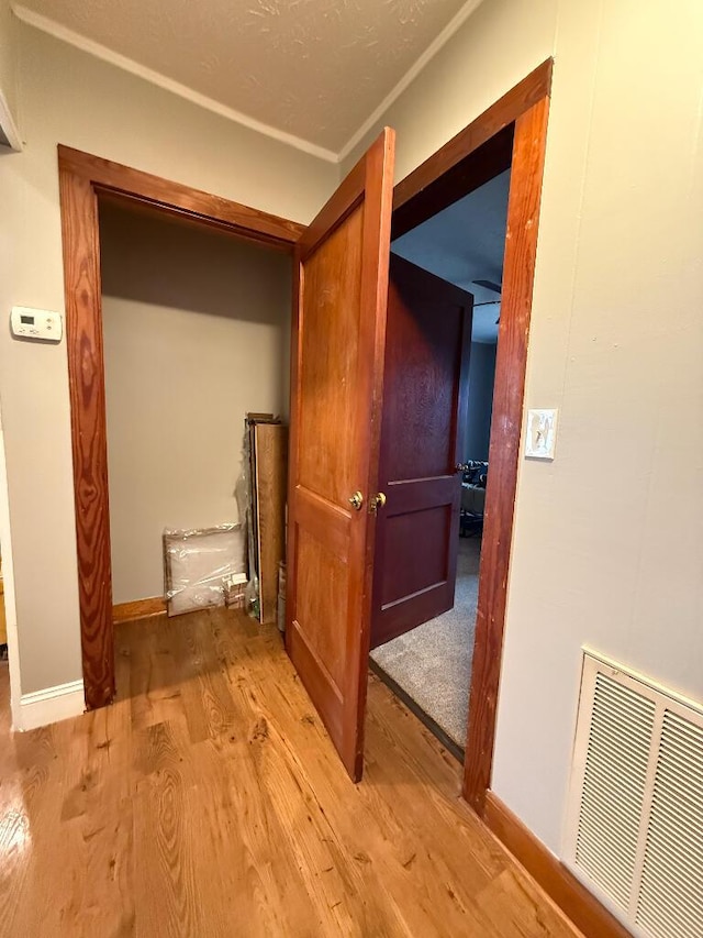 corridor with light hardwood / wood-style floors