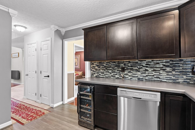 kitchen with dark brown cabinets, dishwasher, decorative backsplash, light wood-type flooring, and wine cooler