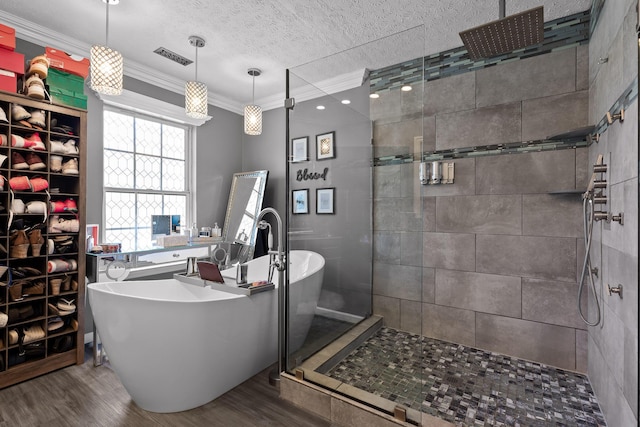 bathroom featuring a textured ceiling, crown molding, independent shower and bath, and wood-type flooring