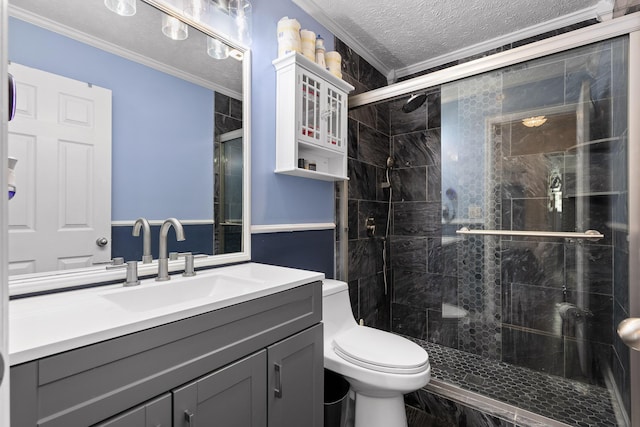 bathroom with vanity, a textured ceiling, toilet, ornamental molding, and a shower with door