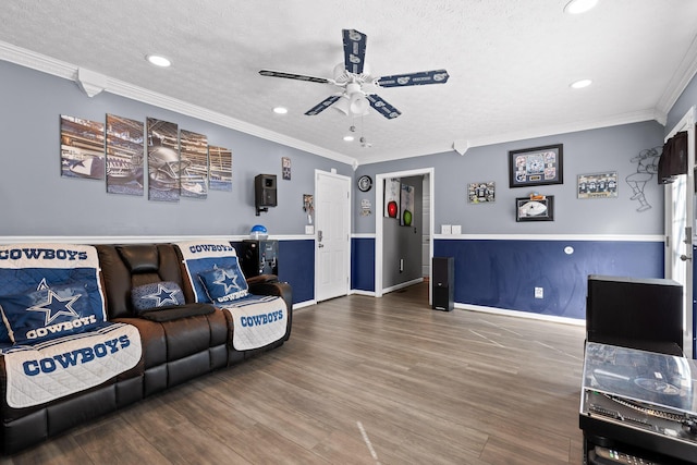 living room with hardwood / wood-style flooring, ornamental molding, a textured ceiling, and ceiling fan