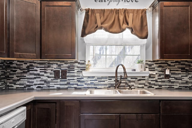 kitchen with sink, dark brown cabinets, tasteful backsplash, and dishwasher