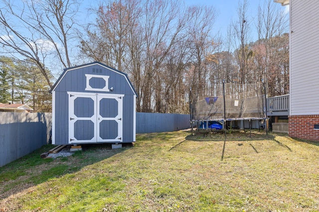 view of yard featuring a shed and a trampoline