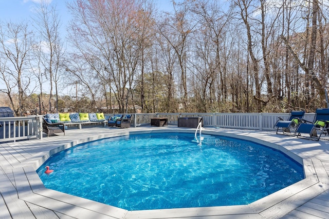 view of pool with a wooden deck