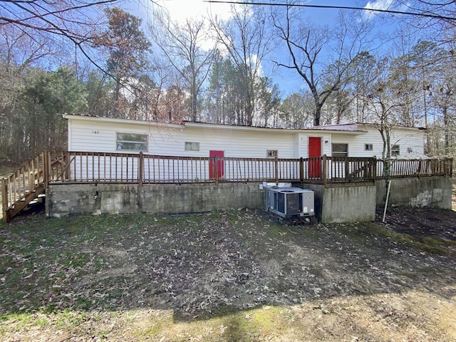 back of property with central AC and a deck