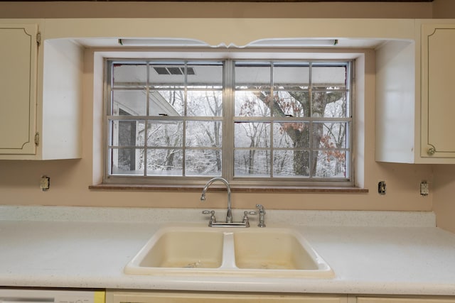 kitchen featuring a sink, light countertops, dishwasher, and plenty of natural light