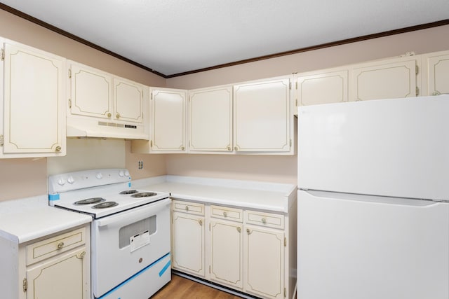 kitchen with white appliances, wood finished floors, light countertops, crown molding, and under cabinet range hood