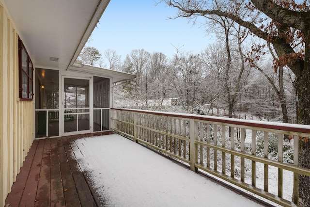 view of snow covered back of property