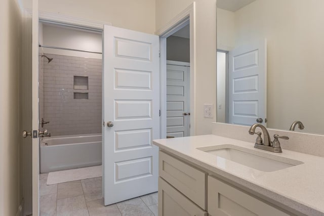 bathroom with tiled shower / bath combo and vanity