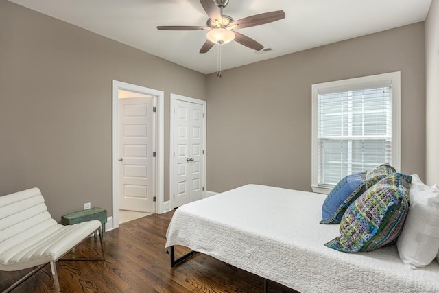 bedroom with ceiling fan and dark hardwood / wood-style flooring